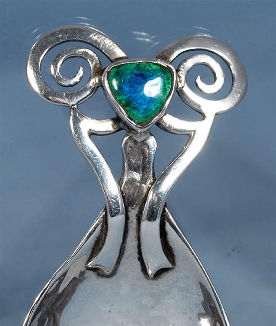 An Edwardian Arts & Crafts silver and enamel caddy spoon, Length 3 ¼”/86mm Width 1 ½”/40mm Weight: 1.2oz/33grms